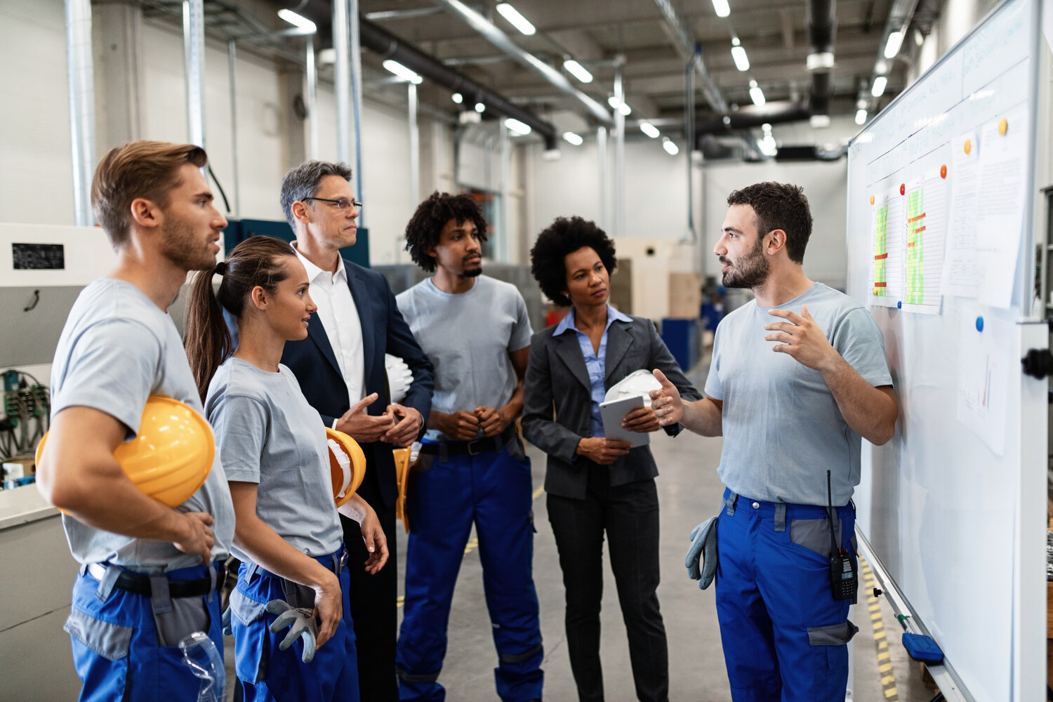 Young factory worker giving presentation of the results of the production development.